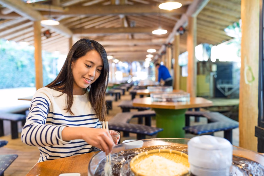 A tourist is trying local Japanese food