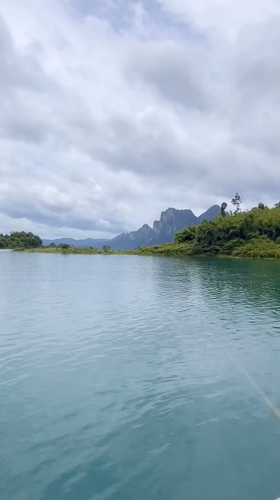 View across Cheow Lan Lake toward a limestone peak